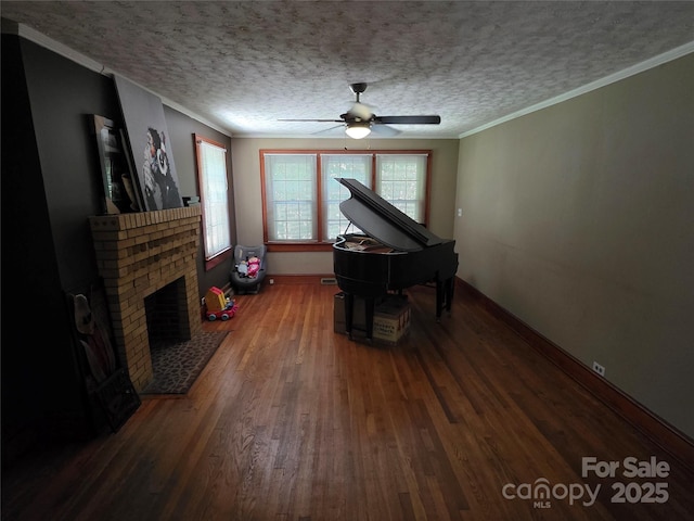 7335 US Highway 52, Salisbury, NC 28146 - living area featuring wood finished floors, ceiling fan, a fireplace, crown molding, and a textured ceiling