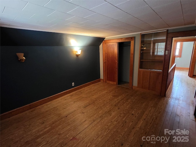 7335 US Highway 52, Salisbury, NC 28146 - empty room with wood-type flooring, built in shelves, and lofted ceiling