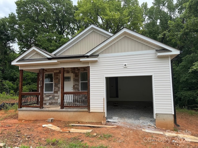 1013 Trexler St, Salisbury, NC 28144 - view of front facade featuring covered porch, board and batten siding, stone siding, and driveway