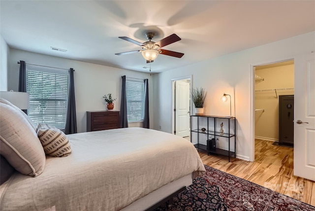 1727 Evergreen Dr, Charlotte, NC 28208 - bedroom with light wood-type flooring, a spacious closet, and ceiling fan