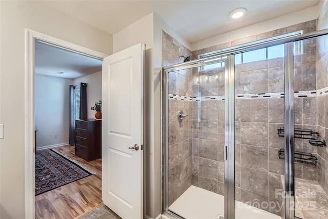 1727 Evergreen Dr, Charlotte, NC 28208 - bathroom with healthy amount of natural light, a stall shower, and wood finished floors