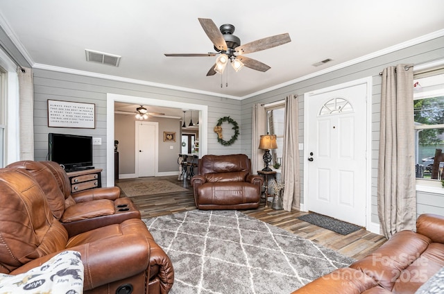 4710 Mooresville Rd, Salisbury, NC 28147 - living room with crown molding, ceiling fan, wood finished floors, and wooden walls