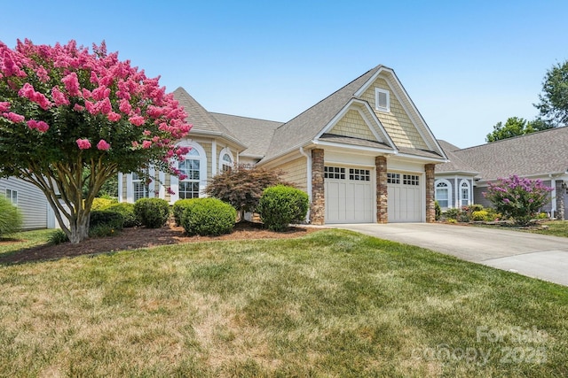 2607 Old Ashworth Ln NW, Concord, NC 28027 - view of front of home with stone siding, an attached garage, concrete driveway, a front yard, and a shingled roof
