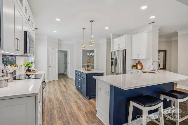 2607 Old Ashworth Ln NW, Concord, NC 28027 - kitchen with stainless steel appliances, blue cabinets, ornamental molding, decorative backsplash, and a center island