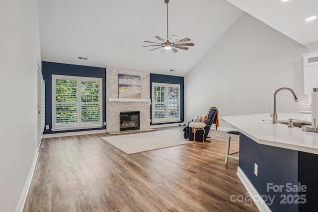 2607 Old Ashworth Ln NW, Concord, NC 28027 - living area with healthy amount of natural light, wood finished floors, vaulted ceiling, ceiling fan, and recessed lighting