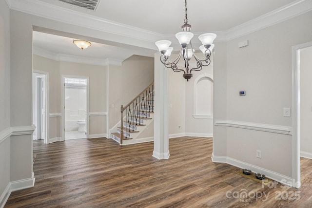 2607 Old Ashworth Ln NW, Concord, NC 28027 - unfurnished dining area featuring dark wood-style flooring, stairs, a chandelier, and crown molding