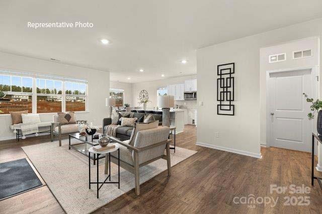 9235 Poquoson Dr, Gastonia, NC 28056 - living room with dark wood-style floors, healthy amount of natural light, and recessed lighting