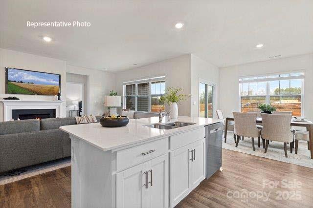 9235 Poquoson Dr, Gastonia, NC 28056 - kitchen featuring dishwasher, open floor plan, wood finished floors, healthy amount of natural light, and recessed lighting