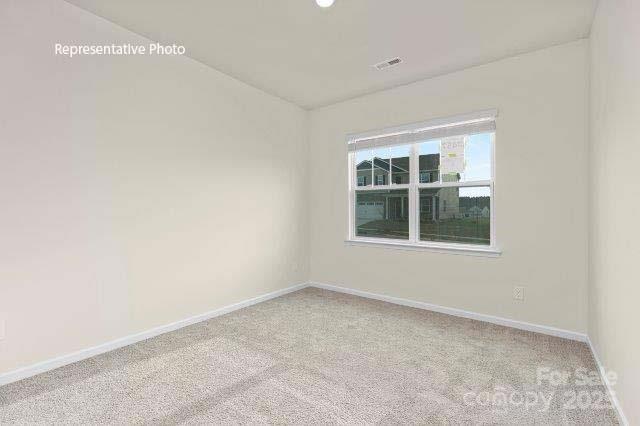 9235 Poquoson Dr, Gastonia, NC 28056 - carpeted empty room with baseboards