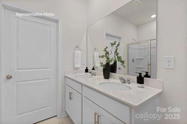 9235 Poquoson Dr, Gastonia, NC 28056 - bathroom with double vanity and a stall shower