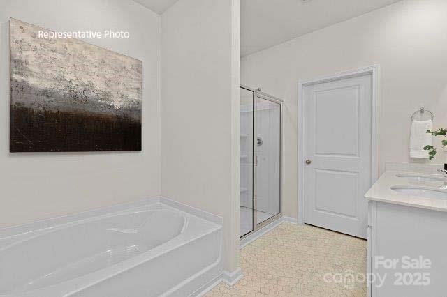 9235 Poquoson Dr, Gastonia, NC 28056 - full bathroom with a shower stall, a bath, double vanity, and tile patterned flooring
