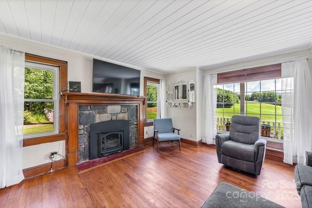 5215 Double Island Rd, Green Mountain, NC 28740 - living area featuring wood finished floors, wood ceiling, crown molding, a wall mounted air conditioner, and a stone fireplace