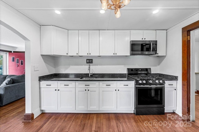5215 Double Island Rd, Green Mountain, NC 28740 - kitchen with appliances with stainless steel finishes, white cabinets, dark wood-type flooring, and dark stone counters