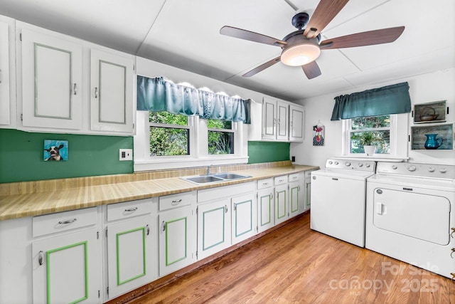 5215 Double Island Rd, Green Mountain, NC 28740 - laundry room featuring washing machine and dryer, cabinet space, a ceiling fan, and light wood-style floors