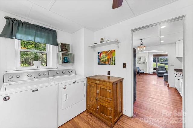 5215 Double Island Rd, Green Mountain, NC 28740 - laundry area featuring washer and clothes dryer, arched walkways, light wood-type flooring, and a ceiling fan