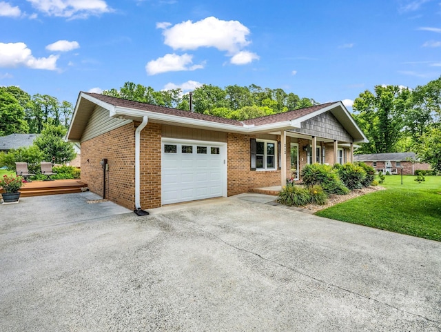 313 Resada Dr, Brevard, NC 28712 - ranch-style house featuring an attached garage, asphalt driveway, a porch, brick siding, and a front lawn