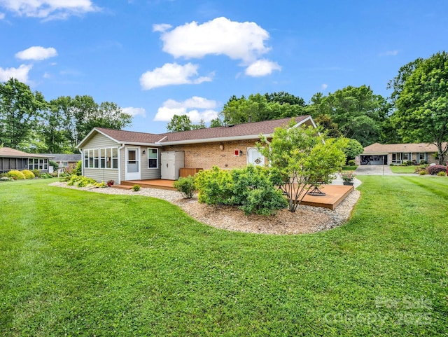 313 Resada Dr, Brevard, NC 28712 - back of house featuring a deck, a yard, and brick siding