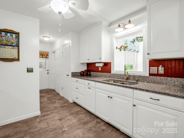 313 Resada Dr, Brevard, NC 28712 - kitchen featuring ceiling fan, wood finished floors, white cabinetry, and dark stone counters