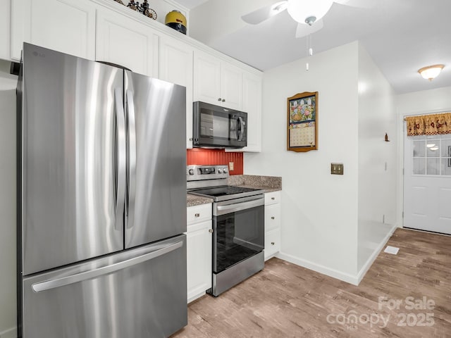 313 Resada Dr, Brevard, NC 28712 - kitchen with appliances with stainless steel finishes, light wood-style flooring, white cabinets, and a ceiling fan