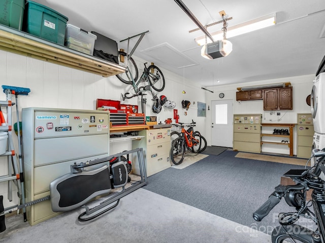 313 Resada Dr, Brevard, NC 28712 - garage featuring stacked washer / dryer, a garage door opener, and electric panel