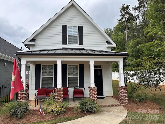 2261 Moss Haven Ln, Denver, NC 28037 - view of front of home with a porch, a standing seam roof, and a metal roof