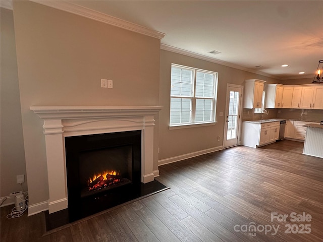 2261 Moss Haven Ln, Denver, NC 28037 - kitchen featuring dishwasher, ornamental molding, white cabinets, dark wood finished floors, and a warm lit fireplace