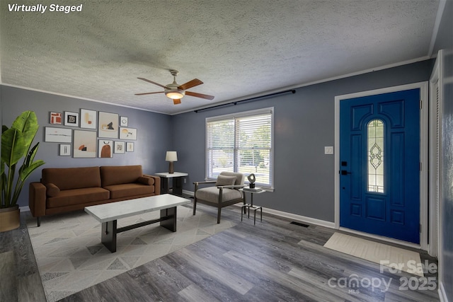 207 Valdese Dr, Morganton, NC 28655 - living room with wood finished floors, a ceiling fan, crown molding, and a textured ceiling