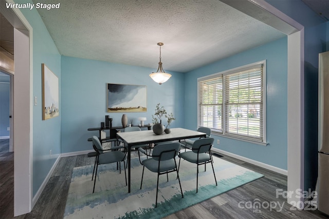 207 Valdese Dr, Morganton, NC 28655 - dining room with wood finished floors and a textured ceiling