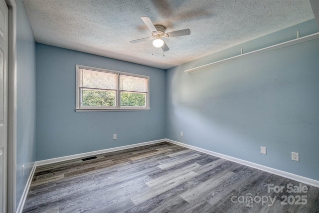 207 Valdese Dr, Morganton, NC 28655 - spare room with a textured ceiling, wood finished floors, and ceiling fan