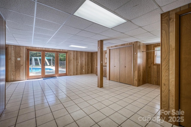 207 Valdese Dr, Morganton, NC 28655 - basement with a drop ceiling, wooden walls, and light tile patterned flooring