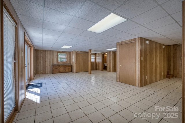 207 Valdese Dr, Morganton, NC 28655 - below grade area featuring a paneled ceiling, wooden walls, and light tile patterned floors
