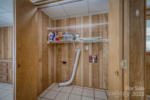 207 Valdese Dr, Morganton, NC 28655 - laundry room with wood walls and light tile patterned floors