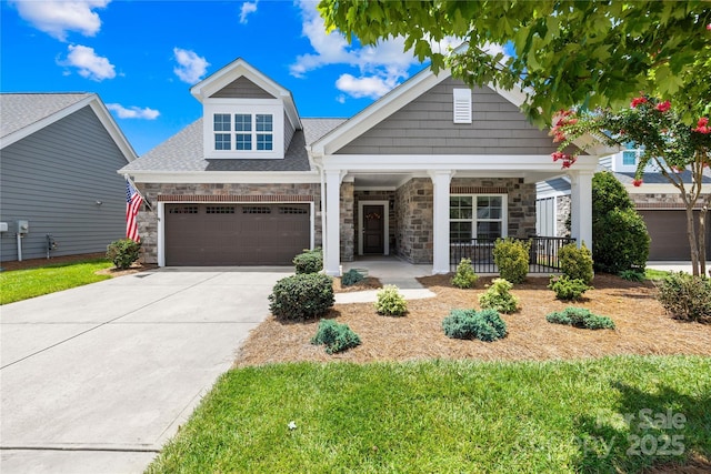 135 Valleymist Ln, Mooresville, NC 28117 - craftsman-style house with a porch, concrete driveway, an attached garage, and a shingled roof