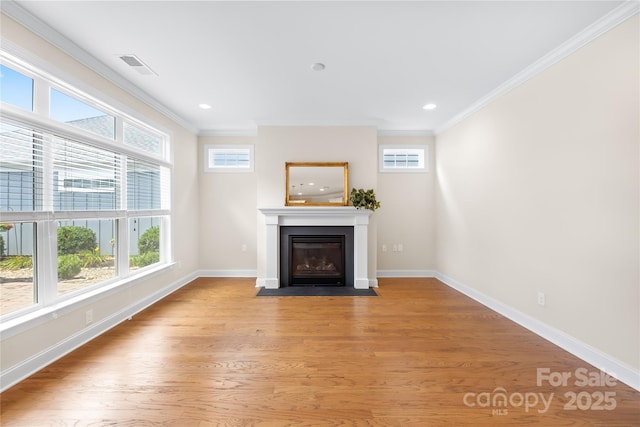 135 Valleymist Ln, Mooresville, NC 28117 - unfurnished living room featuring ornamental molding, plenty of natural light, a fireplace with flush hearth, light wood finished floors, and recessed lighting