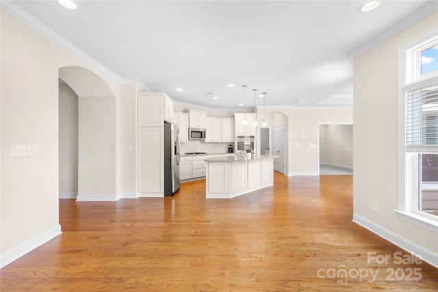 135 Valleymist Ln, Mooresville, NC 28117 - kitchen featuring appliances with stainless steel finishes, arched walkways, open floor plan, recessed lighting, and white cabinets