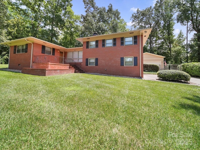 312 Garrison Dr, Albemarle, NC 28001 - view of front of house featuring brick siding, a front lawn, a porch, and stairway