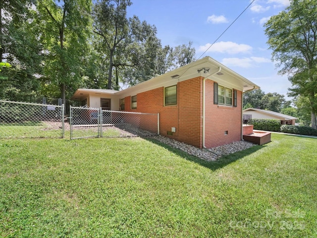312 Garrison Dr, Albemarle, NC 28001 - view of home's exterior featuring a gate and brick siding