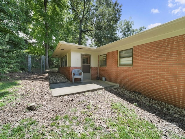 312 Garrison Dr, Albemarle, NC 28001 - rear view of house featuring a patio, brick siding, and a gate