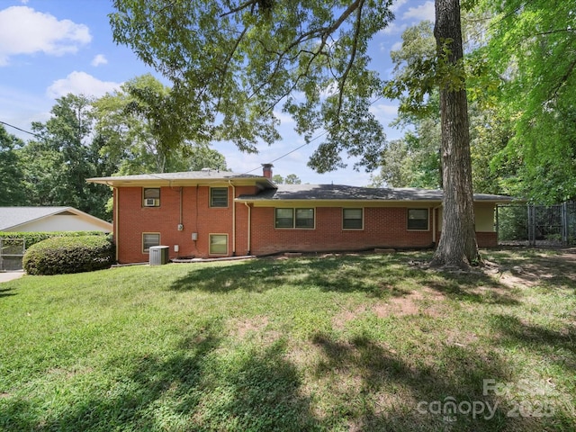 312 Garrison Dr, Albemarle, NC 28001 - rear view of house featuring brick siding and a chimney