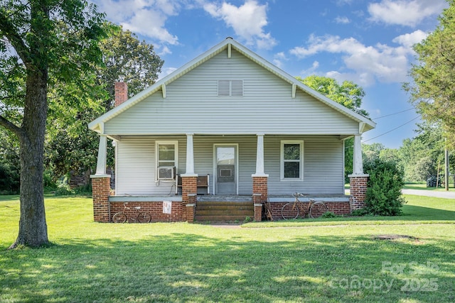 4712 Mooresville Rd, Salisbury, NC 28147 - view of front facade with a front lawn, a porch, a chimney, and cooling unit