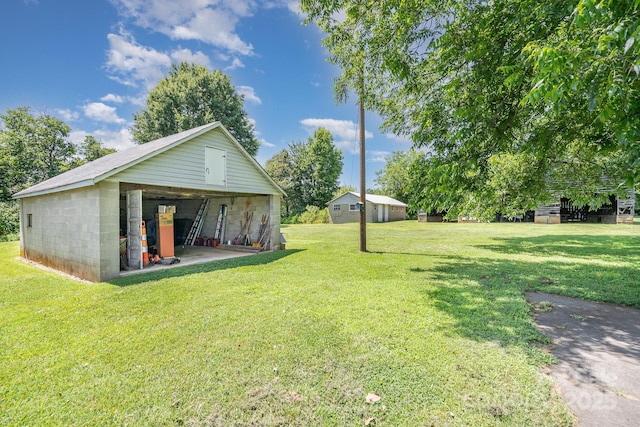 4712 Mooresville Rd, Salisbury, NC 28147 - view of grassy yard featuring an outdoor structure and a detached garage