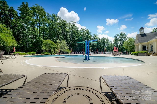 9122 Carneros Creek Rd Unit 25, Charlotte, NC 28214 - community pool with a patio and view of wooded area