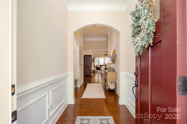 9122 Carneros Creek Rd Unit 25, Charlotte, NC 28214 - entrance foyer featuring crown molding, arched walkways, dark wood-style flooring, and a wainscoted wall