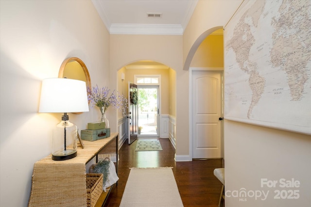 9122 Carneros Creek Rd Unit 25, Charlotte, NC 28214 - entrance foyer with arched walkways, crown molding, dark wood finished floors, wainscoting, and a decorative wall