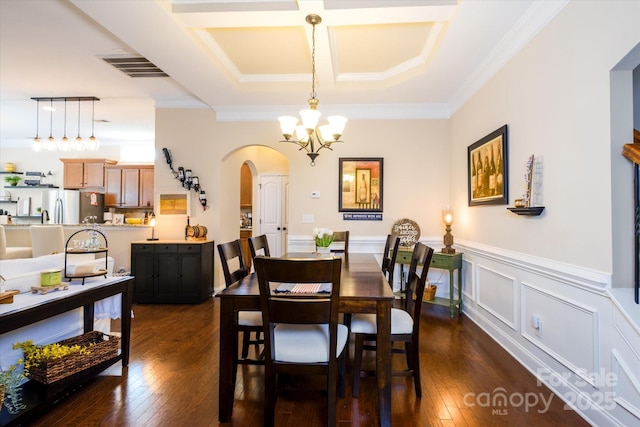 9122 Carneros Creek Rd Unit 25, Charlotte, NC 28214 - dining space with arched walkways, a chandelier, ornamental molding, a wainscoted wall, and dark wood-style floors