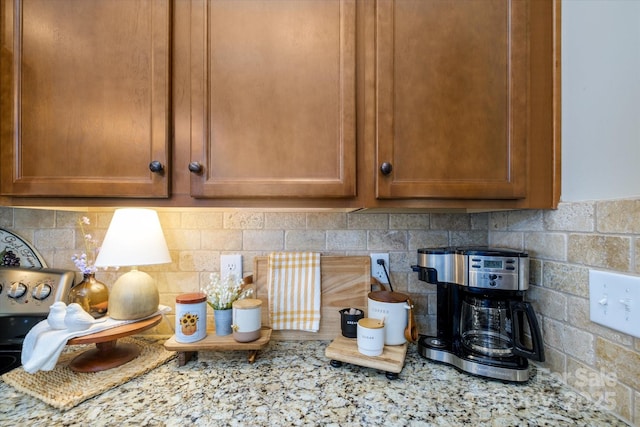 9122 Carneros Creek Rd Unit 25, Charlotte, NC 28214 - kitchen view of tasteful backsplash, brown cabinets, and light stone counters