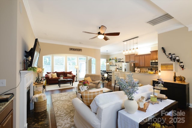 9122 Carneros Creek Rd Unit 25, Charlotte, NC 28214 - living room featuring a ceiling fan, arched walkways, crown molding, and dark wood finished floors