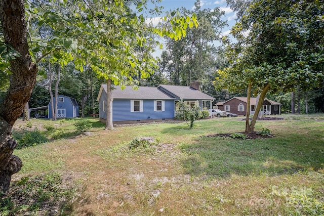 256 Timberland Loop, Mooresville, NC 28115 - view of front of house featuring crawl space, a chimney, a front yard, a storage shed, and view of scattered trees