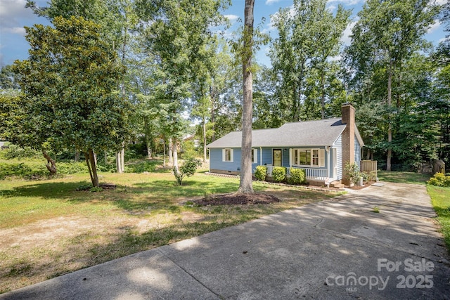 256 Timberland Loop, Mooresville, NC 28115 - view of front of house with concrete driveway, a porch, a chimney, and a front yard