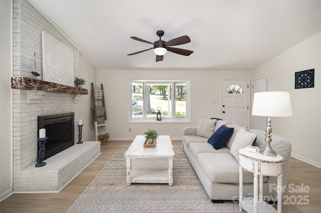 256 Timberland Loop, Mooresville, NC 28115 - living room with a ceiling fan, light wood finished floors, and a fireplace